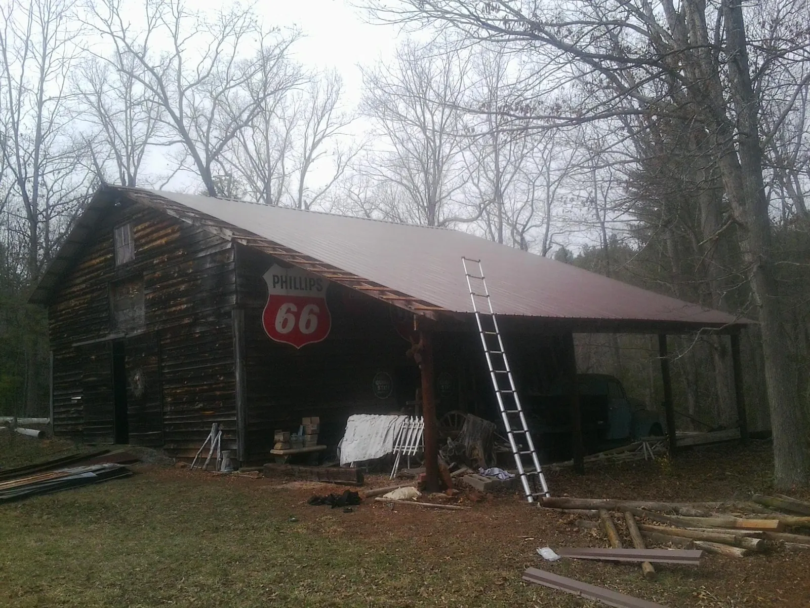 New metal roof on an open sided timber barn with a vintage sign in Pittsfield